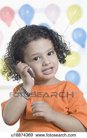 Portrait of a boy talking on a mobile phone View Large Photo Image Stock Photo - Portrait of a boy talking on a mobile phone. Fotosearch