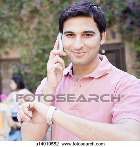 Portrait of a young man talking on a mobile phone View Large Photo Image Stock Image - Portrait of a young man talking on a mobile phone. Fotosearch
