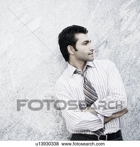 Close-up of a businessman standing with his arms crossed View Large Photo Image Stock Photo - Close-up of a businessman standing with his arms crossed. Fotosearch