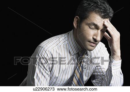 Close-up of a businessman suffering from a headache View Large Photo Image Stock Image - Close-up of a businessman suffering from a headache. Fotosearch