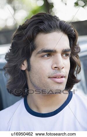Stock Image - Close-up of a young man looking away. Fotosearch