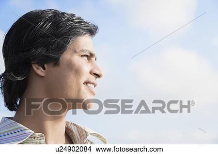 Close-up of a young man smiling View Large Photo Image Picture - Close-up of a young man smiling. Fotosearch