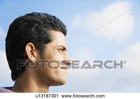 Close-up of a young man smiling View Large Photo Image Stock Image - Close-up of a young man smiling. Fotosearch