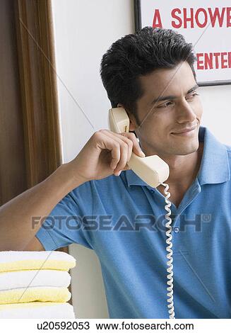 Close-up of a young man talking on the telephone View Large Photo Image Stock Image - Close-up of a young man talking on the telephone. Fotosearch