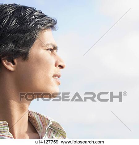 Stock Photo - Close-up of a young man thinking. Fotosearch