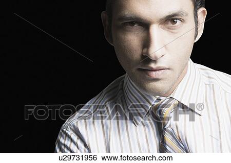 Stock Photograph - Portrait of a businessman looking serious. Fotosearch