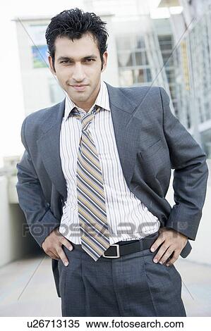 Portrait of a businessman standing with arms akimbo View Large Photo Image Stock Photography - Portrait of a businessman standing with arms akimbo. Fotosearch
