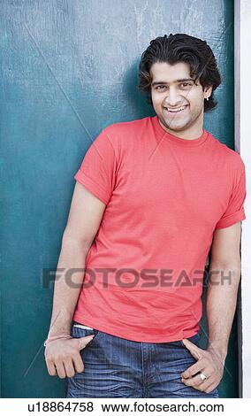 Portrait of a young man leaning against a door and smiling View Large Photo Image Stock Photo - Portrait of a young man leaning against a door and smiling. Fotosearch