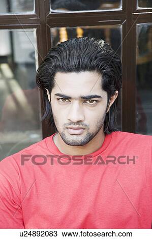 Portrait of a young man looking serious View Large Photo Image Stock Image - Portrait of a young man looking serious. Fotosearch