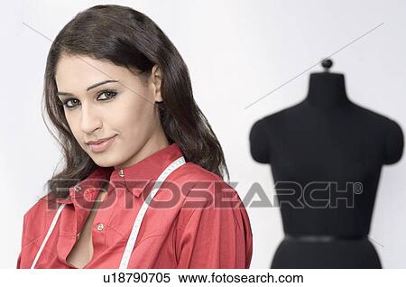 Portrait of a fashion designer with measuring tape around her neck View Large Photo Image Stock Photography - Portrait of a fashion designer with measuring tape around her neck. Fotosearch