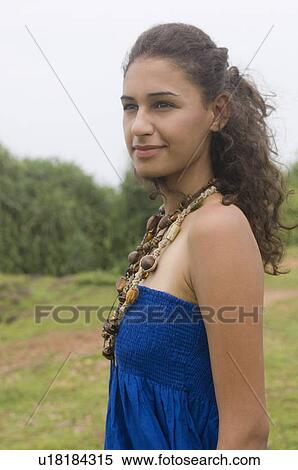 Side profile of a young woman smiling View Large Photo Image Stock Photography - Side profile of a young woman smiling. Fotosearch