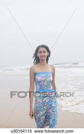 Young woman walking on the beach View Large Photo Image Stock Photography - Young woman walking on the beach. Fotosearch