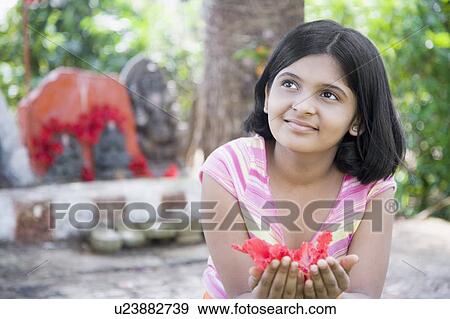 Stock Photo - Close-up of a girl holding flowers. Fotosearch