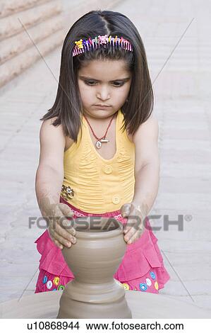 Picture - Close-up of a girl making a pottery. Fotosearch
