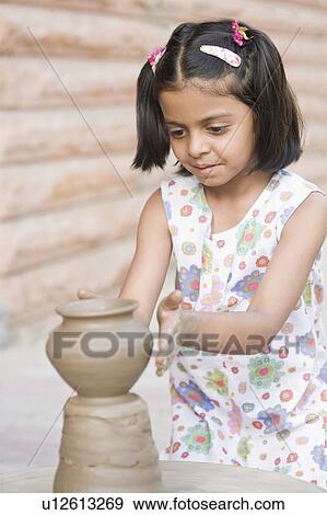 Stock Photo - Close-up of a girl making a pottery. Fotosearch