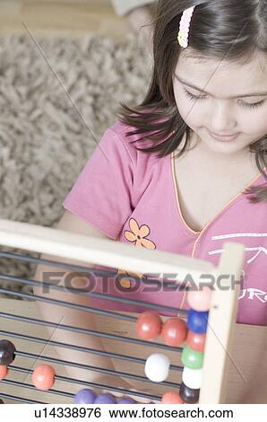 Close-up of a girl playing with an abacus View Large Photo Image Stock Photograph - Close-up of a girl playing with an abacus. Fotosearch