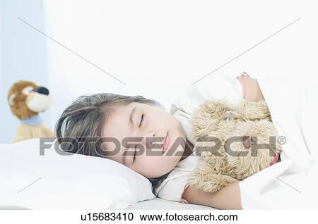 Close-up of a girl sleeping on the bed View Large Photo Image Stock Image - Close-up of a girl sleeping on the bed. Fotosearch