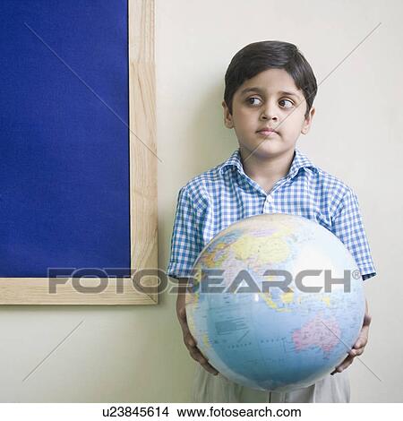 Picture - Close-up of a schoolboy holding a globe. Fotosearch
