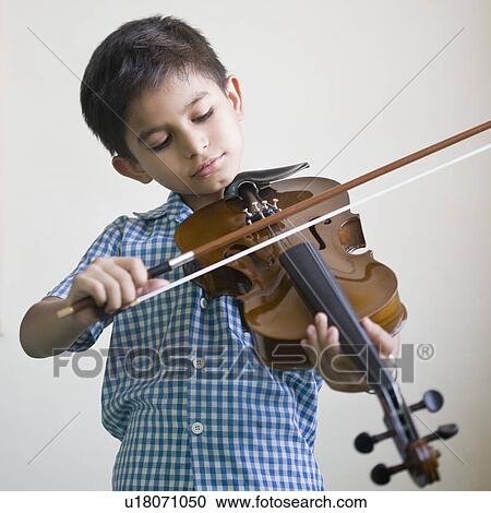 Close-up of a schoolboy playing a violin View Large Photo Image Stock Image - Close-up of a schoolboy playing a violin. Fotosearch