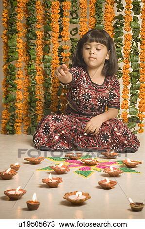 Girl counting oil lamps View Large Photo Image Stock Image - Girl counting oil lamps. Fotosearch