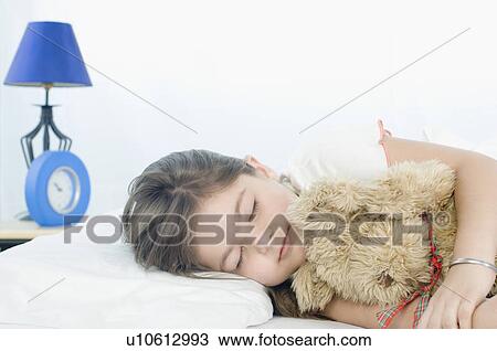 Girl sleeping on the bed View Large Photo Image Stock Image - Girl sleeping on the bed. Fotosearch