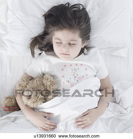High angle view of a girl sleeping on the bed View Large Photo Image Stock Image - High angle view of a girl sleeping on the bed. Fotosearch