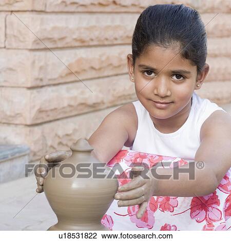 Portrait of a girl making a pottery View Large Photo Image Stock Image - Portrait of a girl making a pottery. Fotosearch