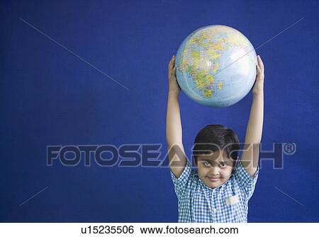 Portrait of a schoolboy holding a globe View Large Photo Image Stock Photograph - Portrait of a schoolboy holding a globe. Fotosearch