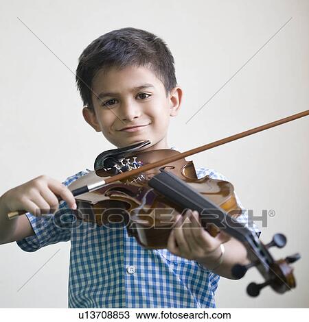 Portrait of a schoolboy playing a violin and smiling View Large Photo Image Stock Image - Portrait of a schoolboy playing a violin and smiling. Fotosearch
