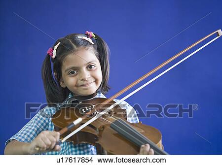 Portrait of a schoolgirl playing a violin and smiling View Large Photo Image Picture - Portrait of a schoolgirl playing a violin and smiling. Fotosearch