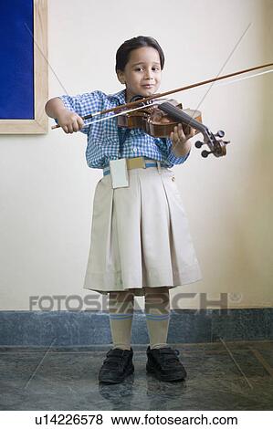 Portrait of a schoolgirl playing a violin in a music class View Large Photo Image Stock Photo - Portrait of a schoolgirl playing a violin in a music class. Fotosearch