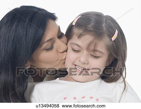 Close-up of a mid adult woman kissing her daughter View Large Photo Image Stock Photo - Close-up of a mid adult woman kissing her daughter. Fotosearch