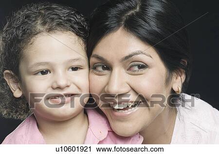 Close-up of a mid adult woman with her daughter smiling View Large Photo Image Stock Image - Close-up of a mid adult woman with her daughter smiling. Fotosearch