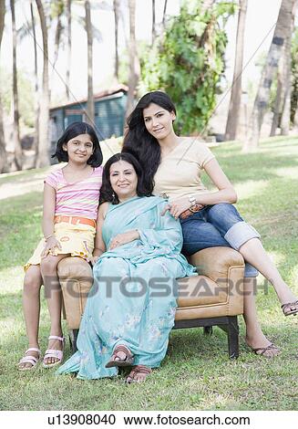 Mature woman sitting in an armchair with her two daughters in a park View Large Photo Image Stock Image - Mature woman sitting in an armchair with her two daughters in a park. Fotosearch