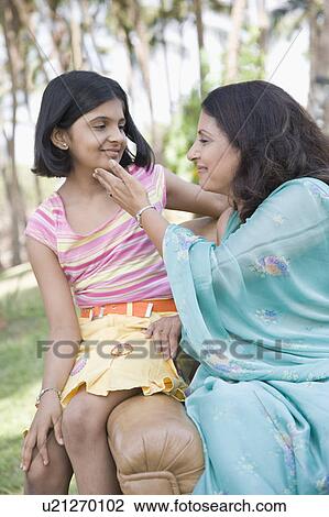 Stock Image - Mature woman sitting with her daughter. Fotosearch