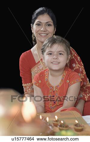 Portrait of a mid adult woman smiling with her daughter View Large Photo Image Picture - Portrait of a mid adult woman smiling with her daughter. Fotosearch
