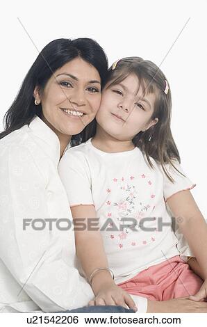 Stock Photograph - Portrait of a mid adult woman smiling with her daughter. Fotosearch