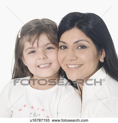 Stock Photography - Portrait of a mid adult woman with her daughter smiling. Fotosearch