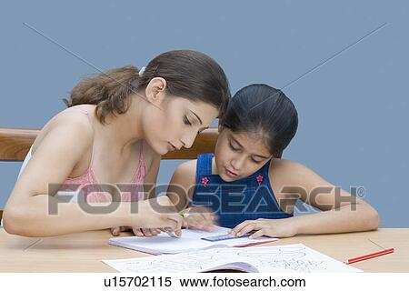 Young woman helping her daughter in drawing View Large Photo Image Stock Photography - Young woman helping her daughter in drawing. Fotosearch