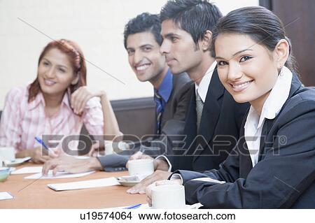 Business executives discussing in a conference room View Large Photo Image Picture - Business executives discussing in a conference room. Fotosearch