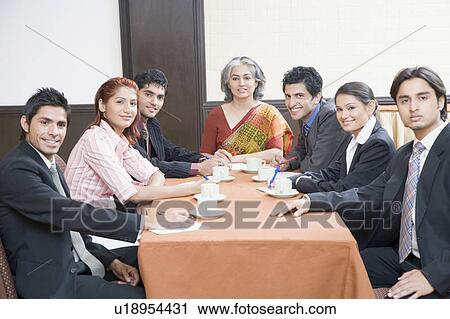 Business executives discussing in a conference room View Large Photo Image Stock Image - Business executives discussing in a conference room. Fotosearch
