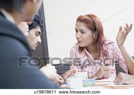 Business executives discussing in a conference room View Large Photo Image Stock Image - Business executives discussing in a conference room. Fotosearch