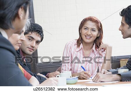 Business executives discussing in a conference room View Large Photo Image Stock Image - Business executives discussing in a conference room. Fotosearch