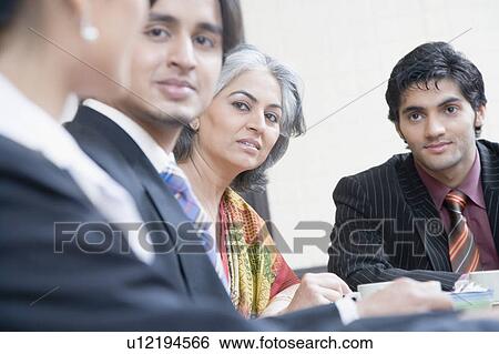 Business executives discussing in a conference room View Large Photo Image Stock Photograph - Business executives discussing in a conference room. Fotosearch