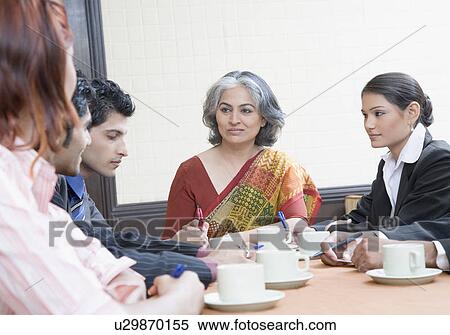 Business executives discussing in a conference room View Large Photo Image Stock Photography - Business executives discussing in a conference room. Fotosearch