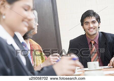 Stock Image - Business executives in a meeting. Fotosearch