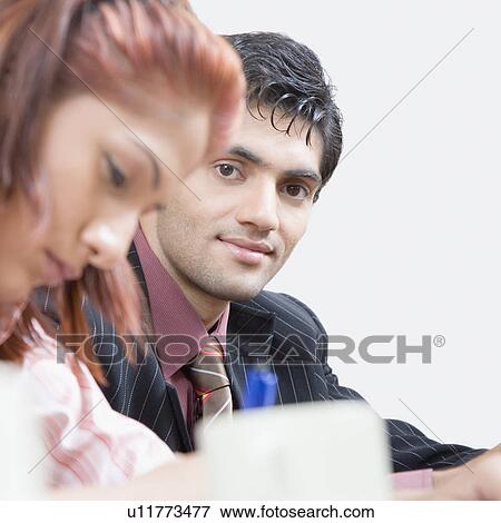 Businesswoman and a businessman in a conference room View Large Photo Image Stock Photo - Businesswoman and a businessman in a conference room. Fotosearch