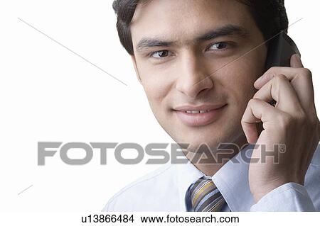 Portrait of a businessman talking on a mobile phone View Large Photo Image Picture - Portrait of a businessman talking on a mobile phone. Fotosearch