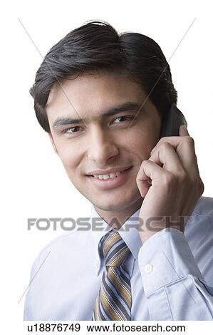 Portrait of a businessman using a mobile phone View Large Photo Image Stock Photo - Portrait of a businessman using a mobile phone. Fotosearch