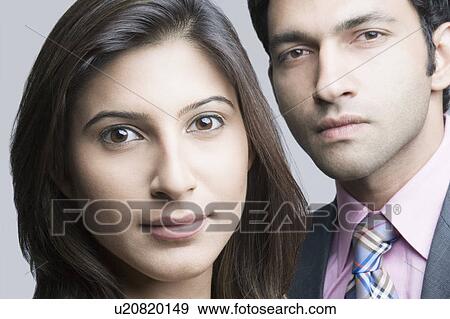 Portrait of a businesswoman and a businessman looking serious View Large Photo Image Stock Photo - Portrait of a businesswoman and a businessman looking serious. Fotosearch